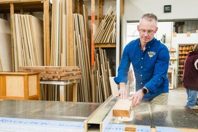 man cutting wood in the workshop