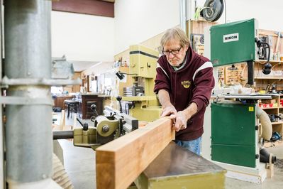 man sanding wood in the workshop