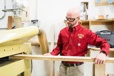 man sanding wood in the workshop