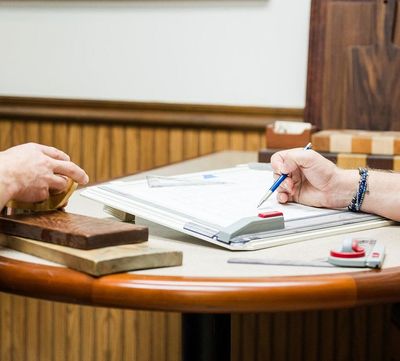 men drawing design plans in a office
