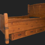 A wooden bed with drawers on the bottom.